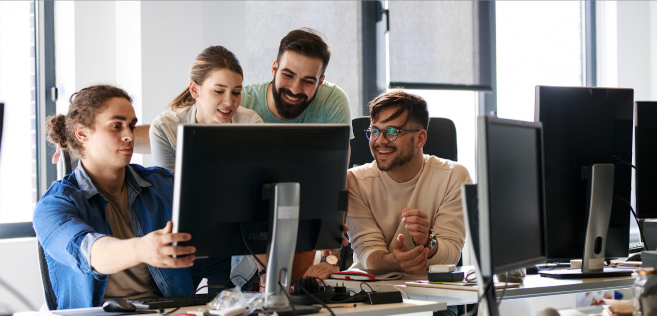 Three people looking at a computer screen
