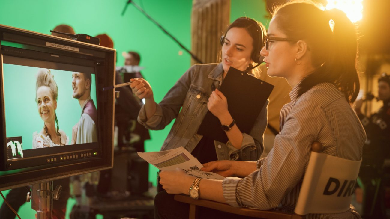 two people looking at a camera monitor