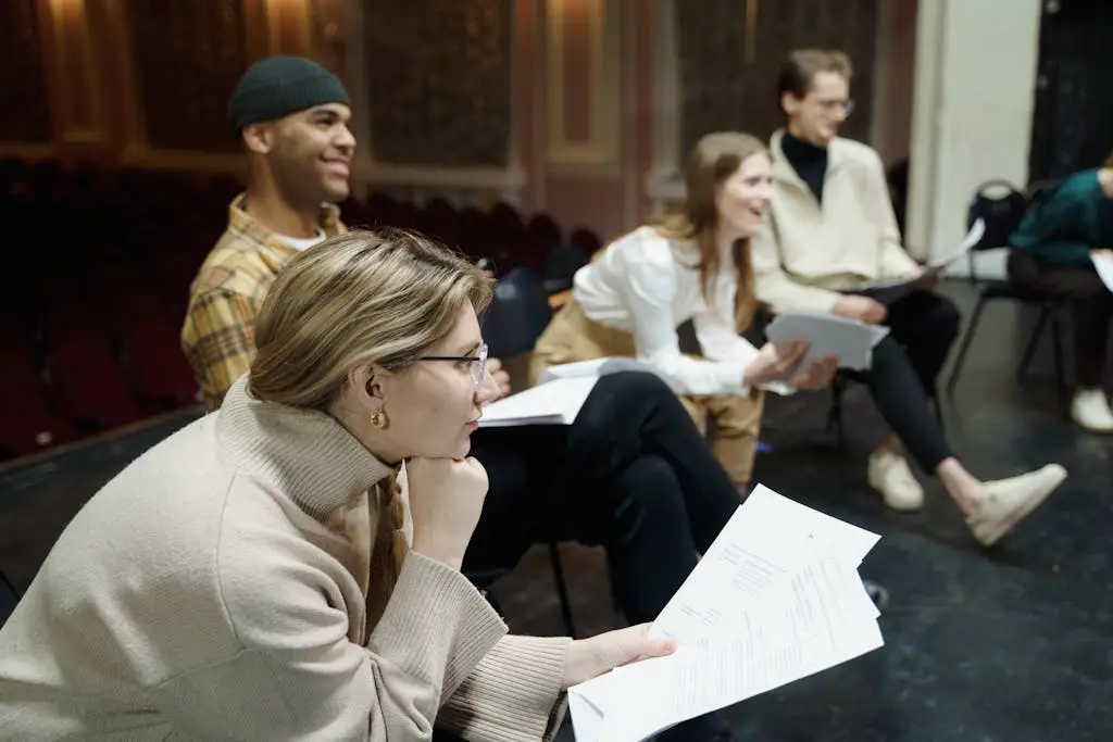 people sitting with paper their hands