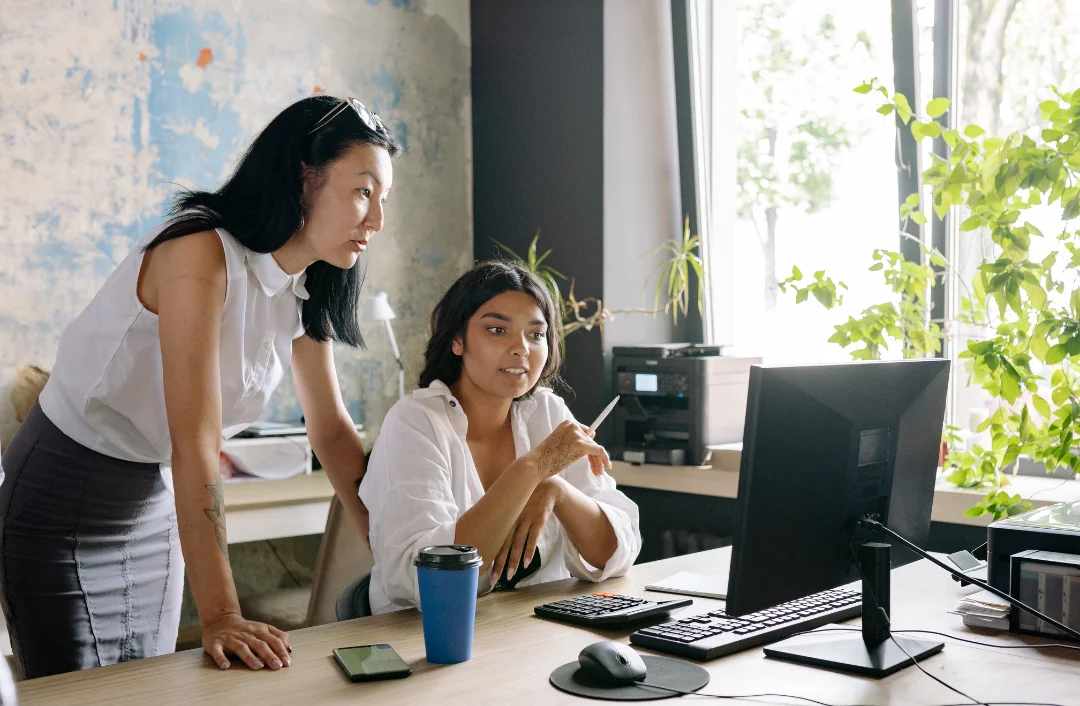 Two women looking at a computer
